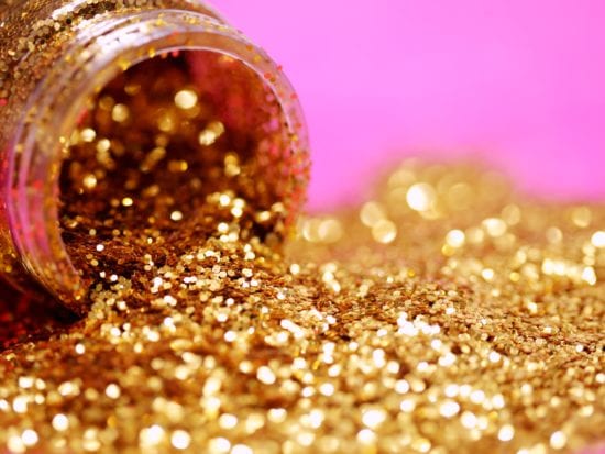 a jar of golden glitter pouring out