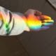 open palm with a rainbow shining across