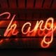 a lit neon sign that says CHANGE